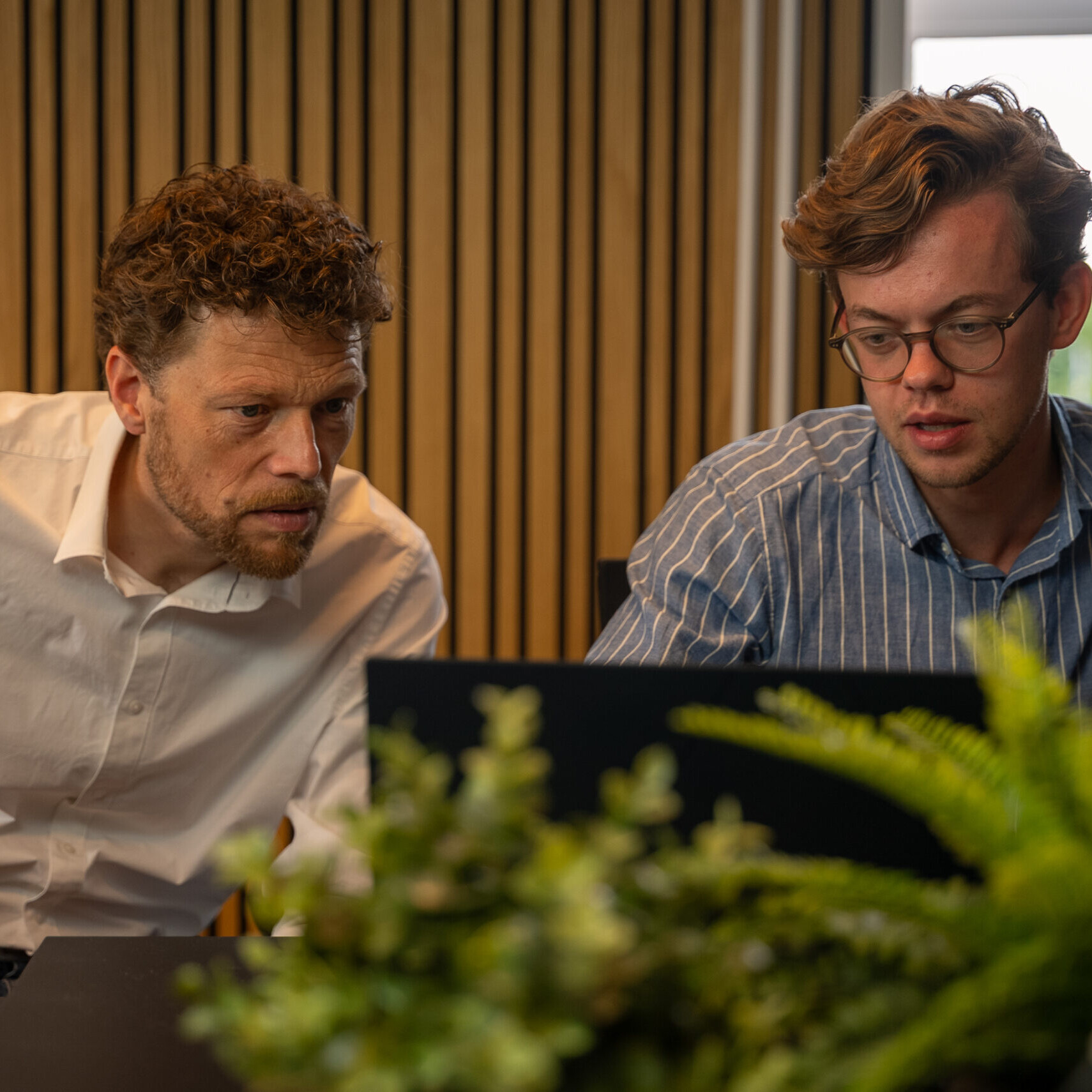 Two marketers working together on a computer